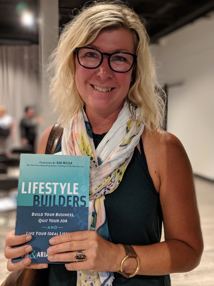 A reader holding a copy of Lifestyle Builders
