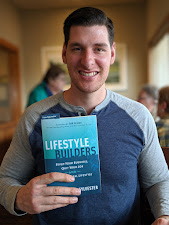 A reader holding a copy of Lifestyle Builders