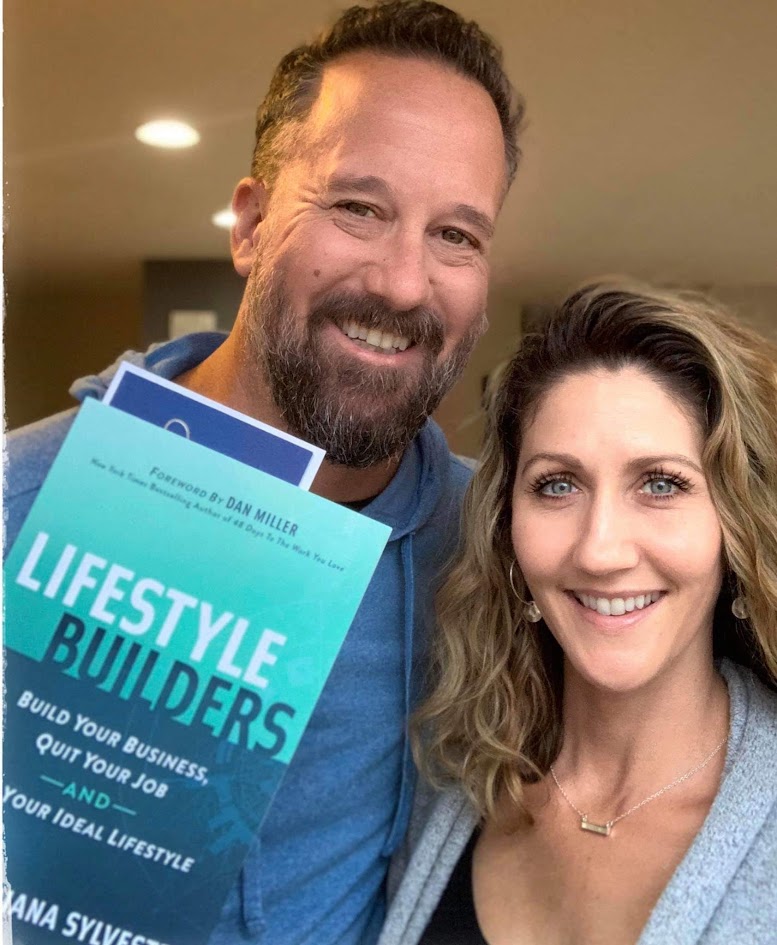 A couple holding a copy of Lifestyle Builders